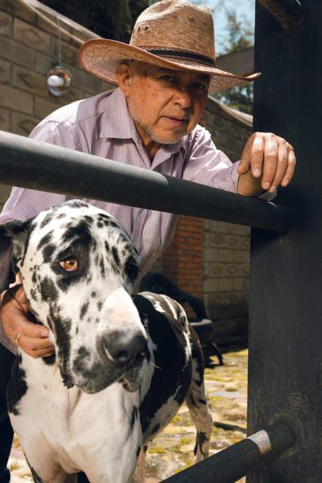 Man with dog at ranch house